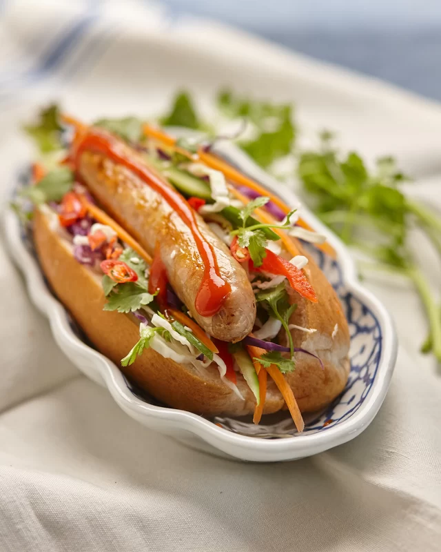 Add some crunchy flare to your next hot dog with some Asian slaw, a drizzle of Srirarcha and a few slices or fresh chilli.Try it before you deny it!#BBQ #hotdog #sausages #asianslaw #porksausages