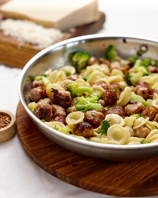 Autumn calls for some beautiful pasta dishes featuring one of our fan favourite sausages - the mighty Cumberland! 🌭This orecchiette pasta with sausage, broccoli and peas is sure to win you plenty of fans. Full recipe below ⬇️INGREDIENTS
8 British Sausage Co. Thin Cumberland Sausages (casings removed and broken into bite size pieces)
350g orecchiette pasta
1 small head of broccoli, cut into small florets
1 cup frozen peas
2 gloves garlic, finely chopped
1 tbsp olive oil
½ cup grated Parmesan or Pecorino Cheese
½ tsp chilli flakes (optional, for a little heat)
Zest of 1 lemon (optional, for a little fresh zing)
Salt and pepper for seasoningMETHOD
1. Cook the Pasta:  Bring a large pot of salted water to a boil. Add orecchiette and cook until al dente, approximately 8 to 10 mins (see directions on pack). Reserve ½ cup of pasta water before draining.
2. Blanch the Broccoli and Peas:  In the last 3 minutes of pasta cooking, add in the broccoli florets and peas to the boiling water. Drain with the pasta and set aside.
3. Brown the Sausage pieces: Heat olive oil in a large frying pan over medium-high heat. Add the sausage pieces and cook until golden and cooked through, about 6–8 minutes.
4. Sauté Garlic & Combine:  Add garlic (and chili flakes if using) to the pan and sauté for 1 minute. Return the pasta and veggies to the pan. Toss everything together, adding reserved pasta water and grated cheese to create a light sauce.
5. Finish & Serve Season with salt, pepper, and lemon zest if using. Serve with more grated cheese and chilli flakes…if you like a little heat!#pastarecipes #sausagepastarecipe #cumberlandsausagerecipes #orecchietterecipes #broccolipastarecipe