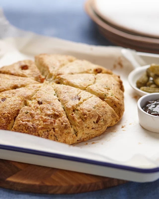 When was the last time you had a savoury scone? We think it's been too long!Whip up this Bacon, Cheese & Chive Scone this weekend and discover what you're missing.Full recipe ⬇️35 mins | Serves 8INGREDIENTS
8 rashers (175g) British Smoked Streaky or Back Bacon, diced and well-cooked
2 1/2 cups (300g) plain flour
1 tbsp baking powder
1 tsp sugar
1/2 tsp salt
1/2 tsp cracked black pepper
6 tbsp (85g) cold unsalted butter, diced
1 cup grated cheddar or tasty cheese
2 tbsp finely chopped fresh chives (or spring onion)
3/4 cup (180ml) full cream milkMETHOD
1. Preheat your oven to 200°C (180°C fan). Line a baking tray with baking paper.
2. In a large mixing bowl, combine flour, baking powder, sugar, salt and pepper. Give it a quick stir or whisk through to ensure dry ingredients are mixed together thoroughly.
3. Add the diced butter and rub into the flour using your fingertips until it resembles coarse breadcrumbs.
4. Mix in cooked bacon, grated cheese and chopped chives until ingredients are evenly distributed.
5. Add in the milk and gently mix through until a dough forms. Do not overwork it.
6. Tip the dough onto a lightly floured surface. Pat it into a circle about 3cm thick. Transfer onto the lined baking tray, then cut dough into 8 wedges. Brush the scones with a little milk.
7. Bake in the oven and bake for 20-25 minutes, or until golden brown on top and cooked through.0
8. When cooked, let slightly cool, then pull apart and enjoy. Best served with a side of pickles and a good dollop of relish or chutney. Don’t forget the cuppa!#sconerecipe #familyrecipes #baconrecipes #baconsconerecipe #mealideas