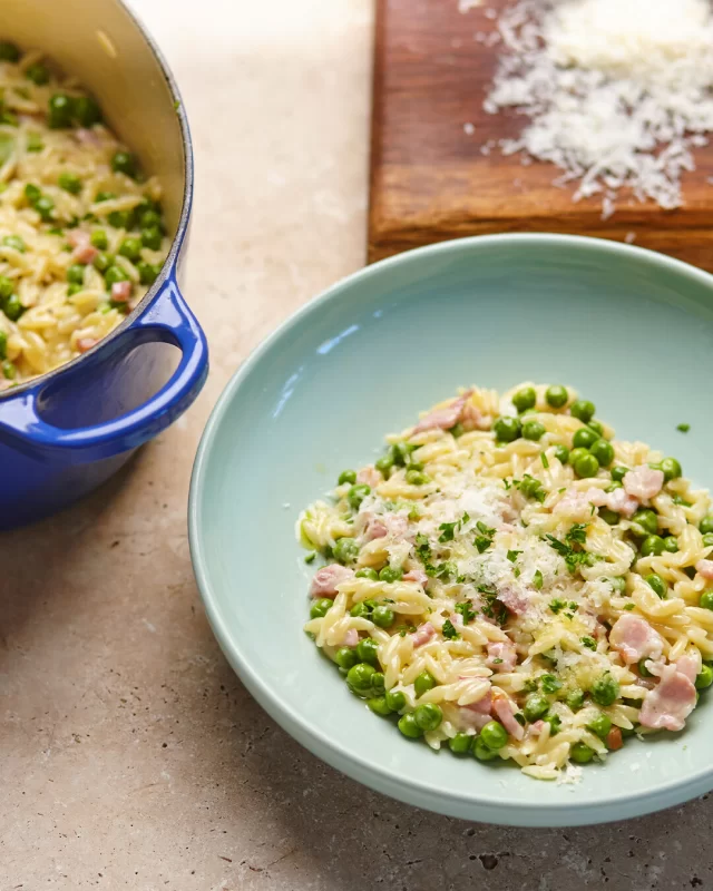 This Pea & Bacon Orzo recipe is another example of how everything is better with our Traditionally Cured Bacon. Perfect for a quick and easy weekday meal!Full recipe below ⬇️Serves: 4 | Prep: 5 to 10 mins | Cook: 20 minsINGREDIENTS
1 pack of British Smoked Streaky or Back Bacon, diced
250g orzo pasta
2 cups chicken or vegetable stock
1 cup frozen peas
1 small brown onion, finely diced
2 gloves garlic, finely chopped
1 tbsp olive oil
½ cup cream
½ cup grated Parmesan plus extra to serve
½ tsp chilli flakes (optional, for a little heat)
Zest of 1 lemon (optional, for a little fresh zing)
Salt and pepper for seasoningMETHOD
1.	Crisp the bacon: Heat the olive oil in a deep frypan over medium heat. Add the bacon and cook for 5-7 minutes until golden.2.	Soften the base:  Add the onion and cook for a further 3 minutes until softened. Add the garlic and cook for 30 seconds until fragrant.3.	Cook the Orzo: Stir in the orzo. Then add the stock and bring to a gentle simmer. Reduce the heat and cook for 8 to 20 minutes, stirring occasionally until the orzo is tender and most of the liquid has been absorbed.4. Add peas and cream:  Stir through the peas and cream and cook for a further 2 to 3 minutes until the orzo is creamy and glossy.5.	Finish & Serve Stir through the Parmesan and season well with salt and pepper. If opting for a little zesty flavour, add the lemon zest and stir through. Serve immediately and top with extra Parmesan. Serve with more grated cheese and some chilli if your partial to some heat!GREEN UP
Feeling virtuous? Toss in a cup of spinach and grated zucchini for an easy green boost.#orzorecipe #pastarecipe #baconrecipe #easymealideas #midweekrecipes