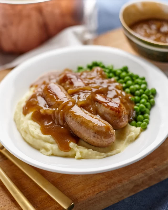 When was the last time you had sausages and mash? Revisit the cold weather classic this weekend with our Cumberland Sausages 🤤FULL RECIPE ⬇️Ingredients
British Sausage Co. Angus Beef and Caramelised Onion Sausages or British Sausage Co. Cumberland Sausages
Vegetable oil
2 large brown onions, thinly sliced
1 tablespoon thyme leaves, chopped
2 bay leaves
1 ½ tablespoons plain flour
150ml red wine
250ml (1 cup) beef stock
1 ½ teaspoons Dijon mustard
1 tablespoon sugar
Splash of red wine vinegar (optional)Mash
1kg red or blue potatoes, peeled and chopped
40g butter, melted
1/2 cup milk, warmed
Extra melted butter, to serveMETHOD
Preheat oven to 140°C.
Pan fry or oven bake the sausages as per our suggested cooking tips on the back of pack.
Place onions in the pan and cook over medium-low heat, stirring occasionally, for 10 minutes or until very soft and golden brown.
Meanwhile, start mash. Place potatoes in a large saucepan. Cover with cold water. Bring to the boil over high heat. Boil for 15 minutes or until potato is soft. Drain.
To make the gravy, add herbs and flour to onion and cook until flour starts to turn light golden. Add wine and simmer for a few minutes, then add stock, mustard, sugar and vinegar. Cook for 1-2 minutes. Return sausages to pan, increase heat to medium and cook in gravy for 5 minutes.
To finish the mash, add butter and milk to potatoes and mash with a potato masher until fluffy. Season to taste with salt and pepper.
Divide potato between plates, add sausages and serve with onion gravy.#comfortfood #sausageandmash #britishfood #dinnerideas #sausagerecipes
