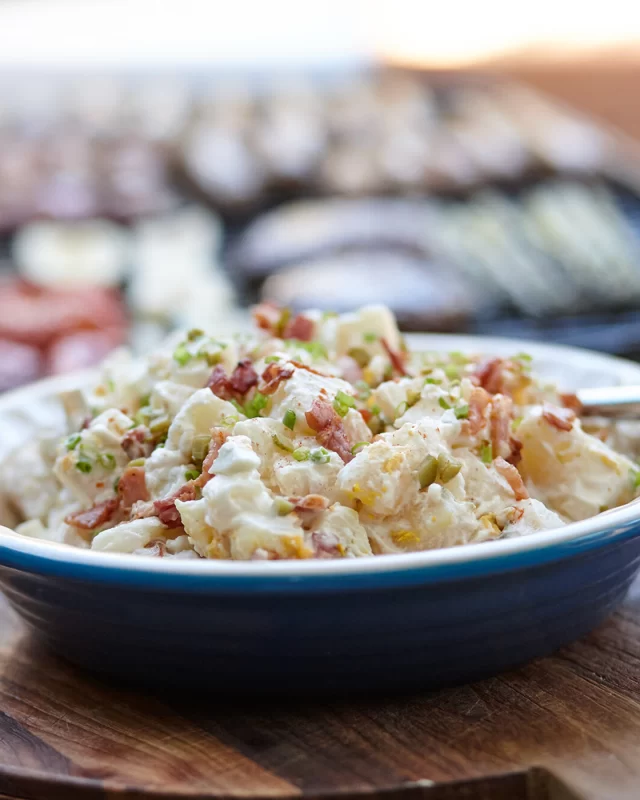 Spring BBQs are the perfect time to whip up a classic potato salad 😍 We've created our own twist with the addition of smoked paprika to add more depth of flavour.

FULL RECIPE ⬇️

INGREDIENTS
200g British Sausage Ham & Bacon Co Traditional Back Bacon, diced
1kg Royal Blue Potatoes, whole and unpeeled
4 hard boiled eggs, slices (save one for serving)

Dressing:
½ cup whole-egg mayonnaise
¼ cup sour cream
1 tbsp cider vinegar
1 tbsp water
1 tsp of smoked paprika
1 tbsp of finely chopped gherkins
Salt, pepper for seasoning
2 tbsp chopped chives

METHOD
1. Place potatoes in large saucepan and cover with water, with ½ teaspoon of salt. Bring to boil, then cook for 10 to 12 minutes, or until tender. Drain and let cool down.

2. While potatoes are cooling, heat a large fry pan and add bacon. Cook the bacon on medium heat for 5 minutes or until bacon is deliciously crispy. Turn heat off.

3. Peel skins off potatoes, then cut into approximately 2cm x 2cm cubes and place into bowl with 3 of the chopped eggs

4. Combine mayonnaise, sour cream, smoked paprika, chopped gherkins and vinegar and mix through the chopped potatoes, egg, most of the chopped chives and most of the diced cooked bacon. Taste and then season with salt and pepper. Toss through to combine all ingredients.

5. Place into serving bowl and top with remaining sliced egg, bacon and chopped chives.

#potatosalad #bacon #australianbacon #springbbq #bbq